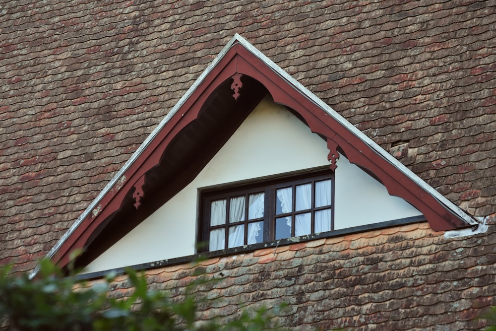 a close up of a roof with a window