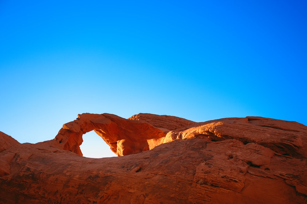 a large rock formation with a small arch in the middle of it