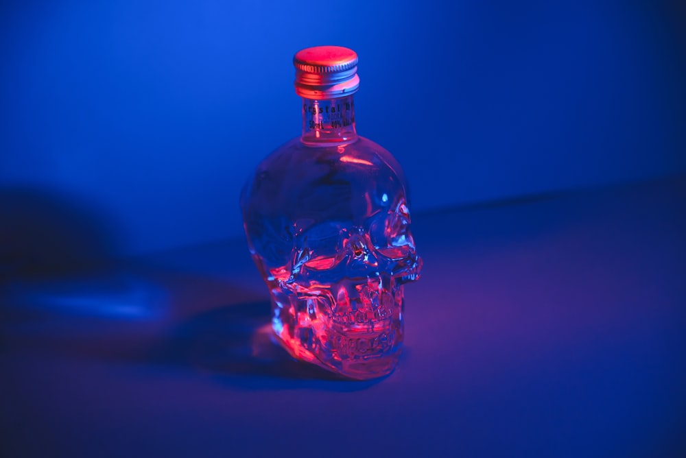 a glass bottle with a red light inside of it