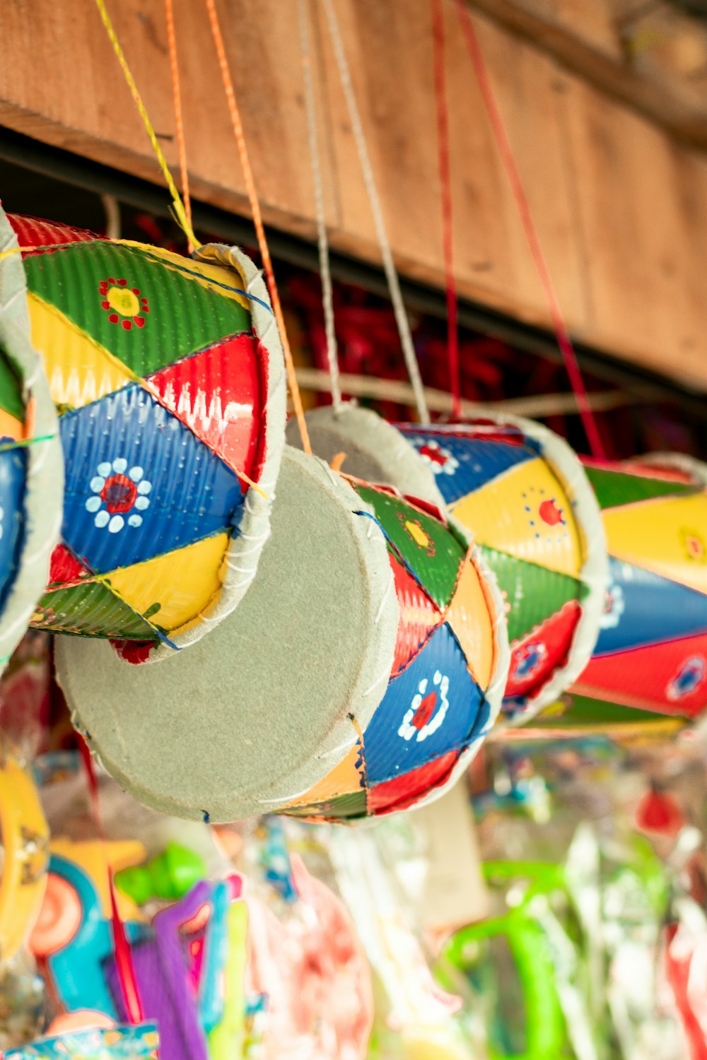 a group of colorful paper lanterns hanging from a ceiling