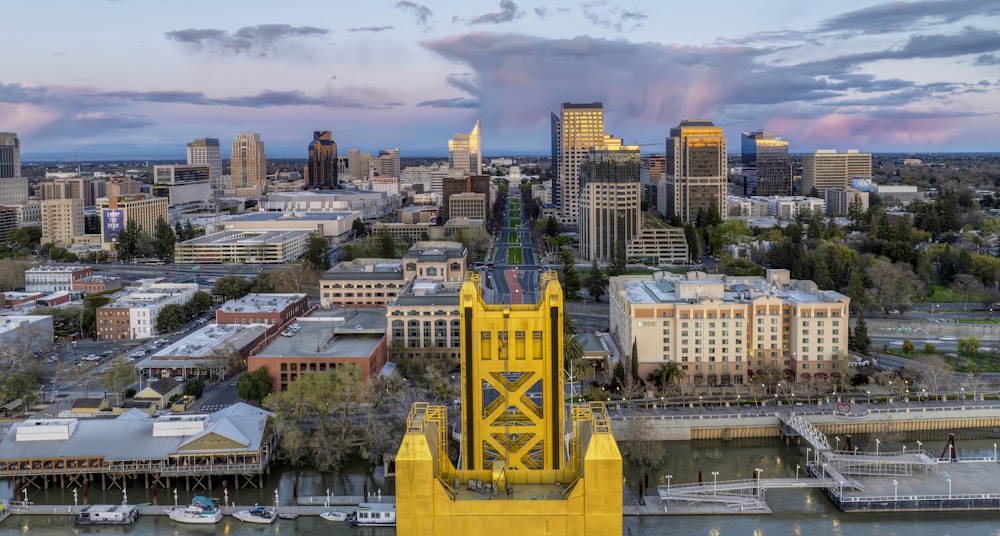 a view of a city with a yellow tower