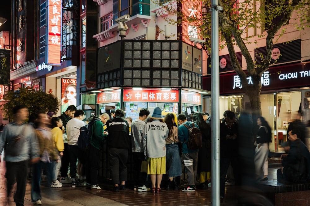 a group of people standing outside of a store