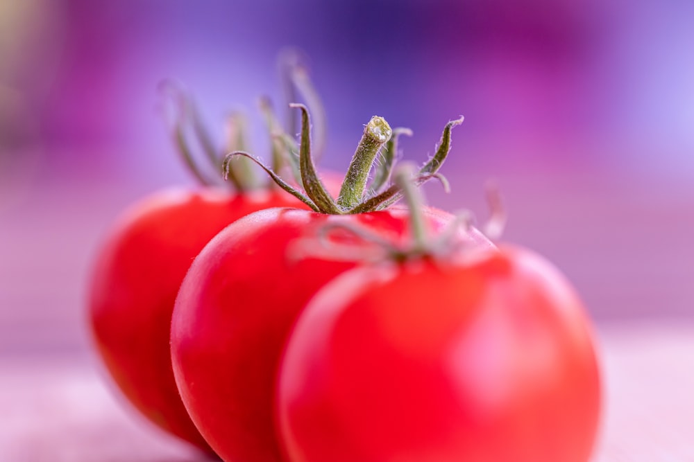 a close up of two tomatoes on a table