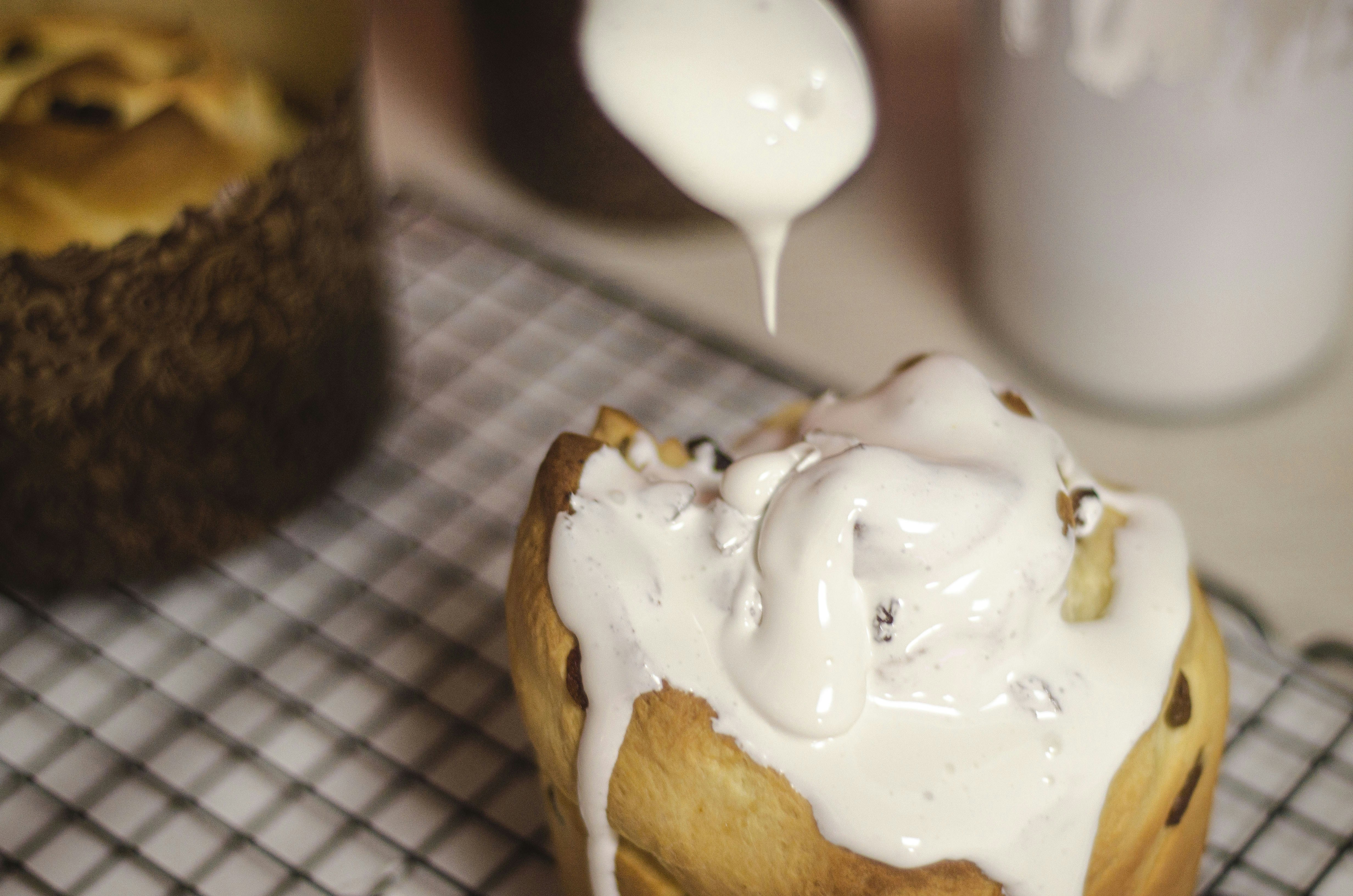 Icing poured on a cinnamon roll