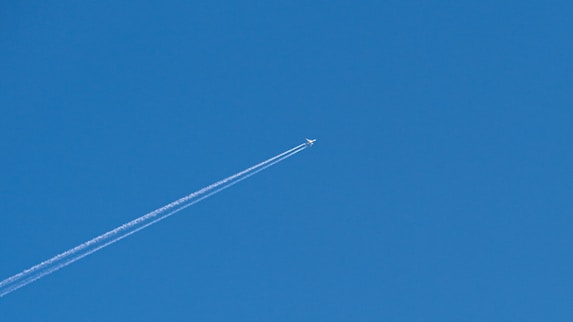 an airplane is flying high in the sky