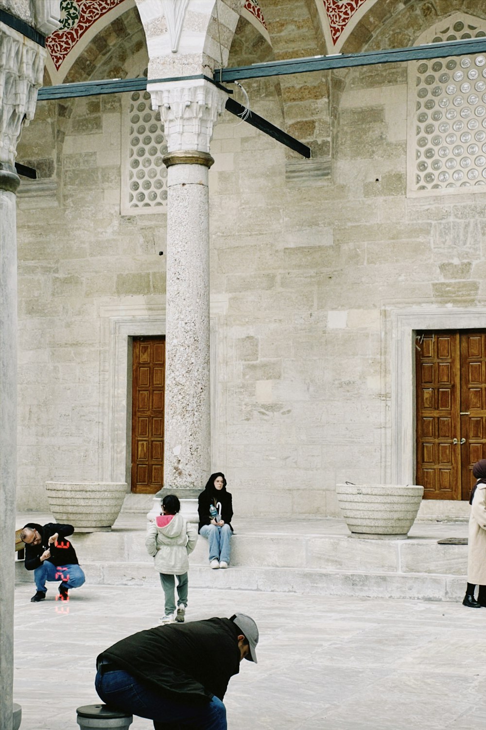 a man kneeling down in front of a building