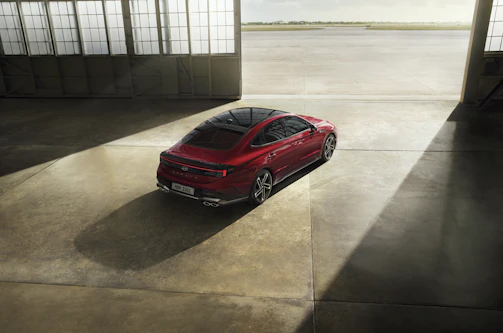Interior view of a spacious luxury hangar featuring polished concrete floors and custom lighting.
