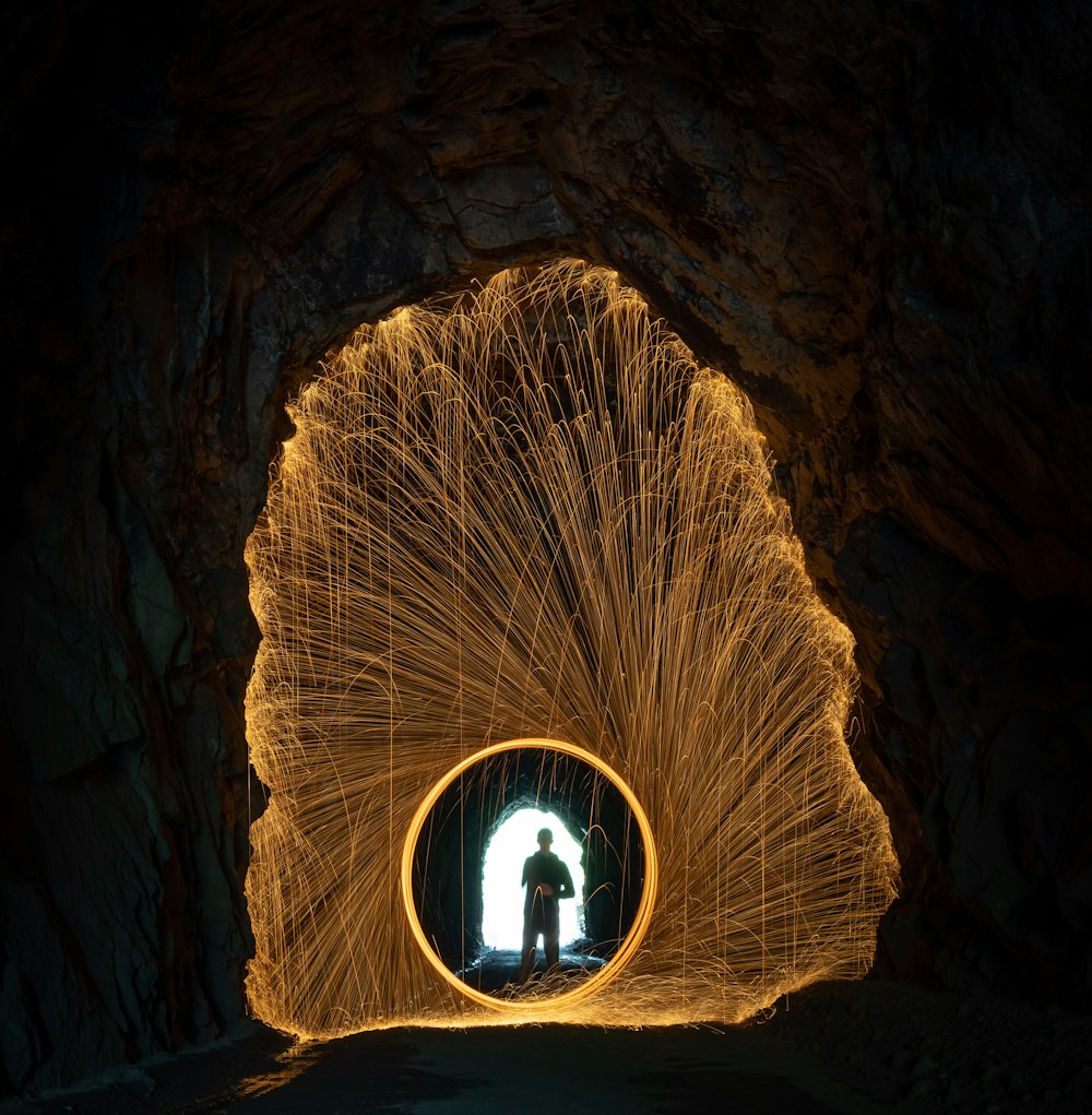 a man standing inside of a tunnel filled with sparks