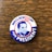A vintage campaign button featuring a portrait with the text 'WALLACE FOR PRESIDENT.' The background includes red, white, and blue colors with a stylized eagle symbol.