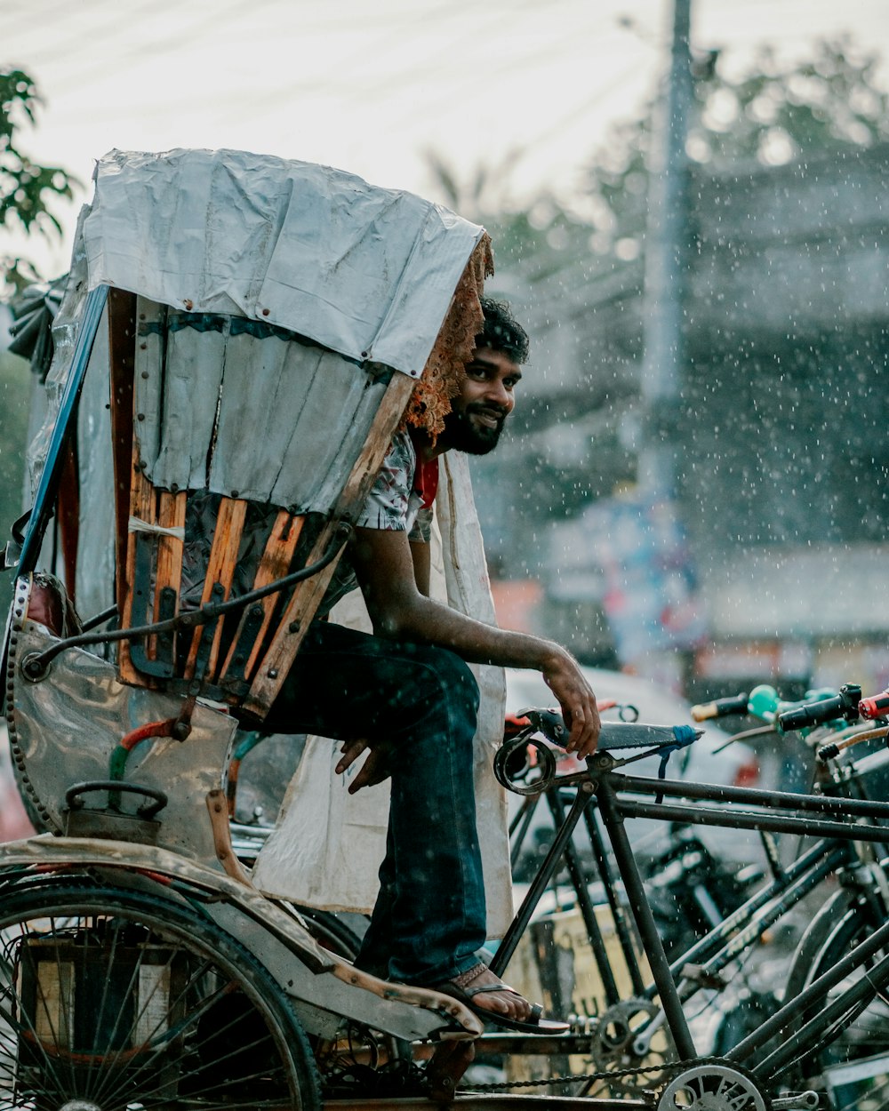 a man sitting on top of a rickshaw