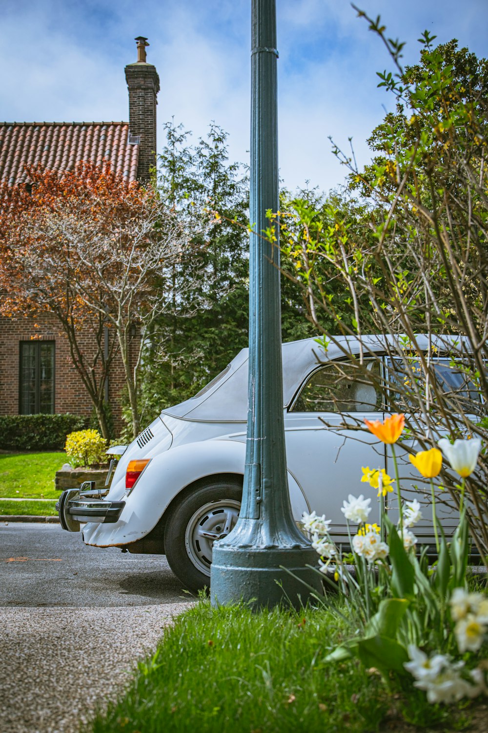 a white car parked next to a street light