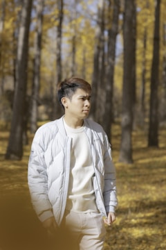 Woman hiking in the woods wearing a breathable, insulated jacket from our collection.