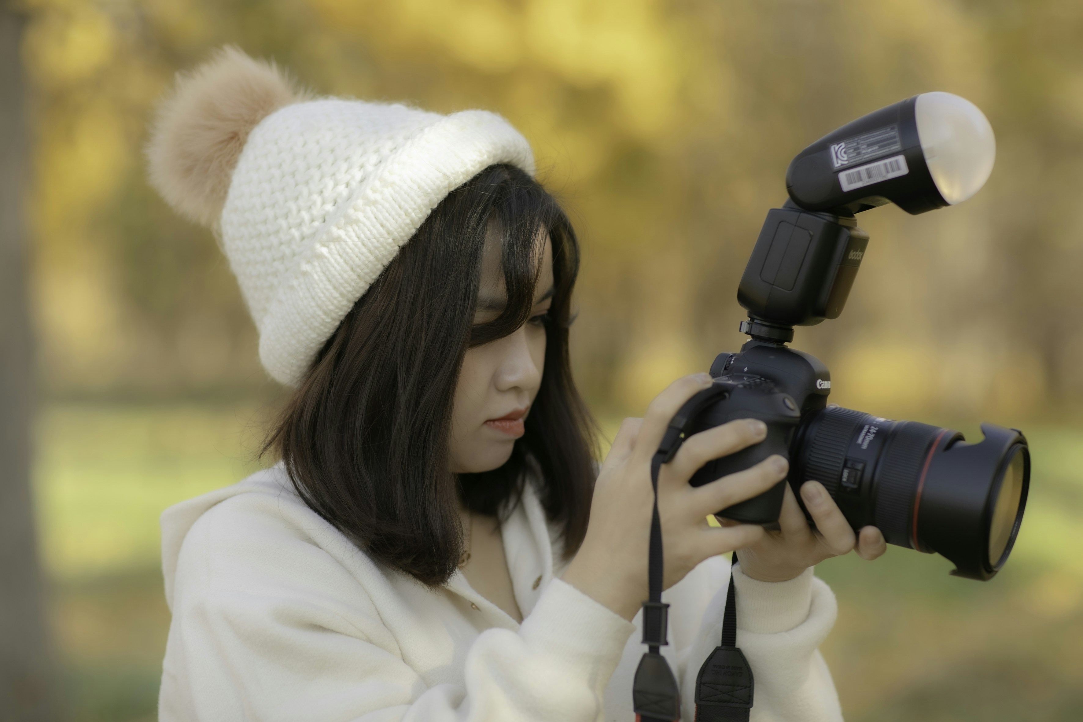 a woman is holding a camera and taking a picture