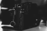 Close-up of a professional camera capturing a live event in a dark venue.
