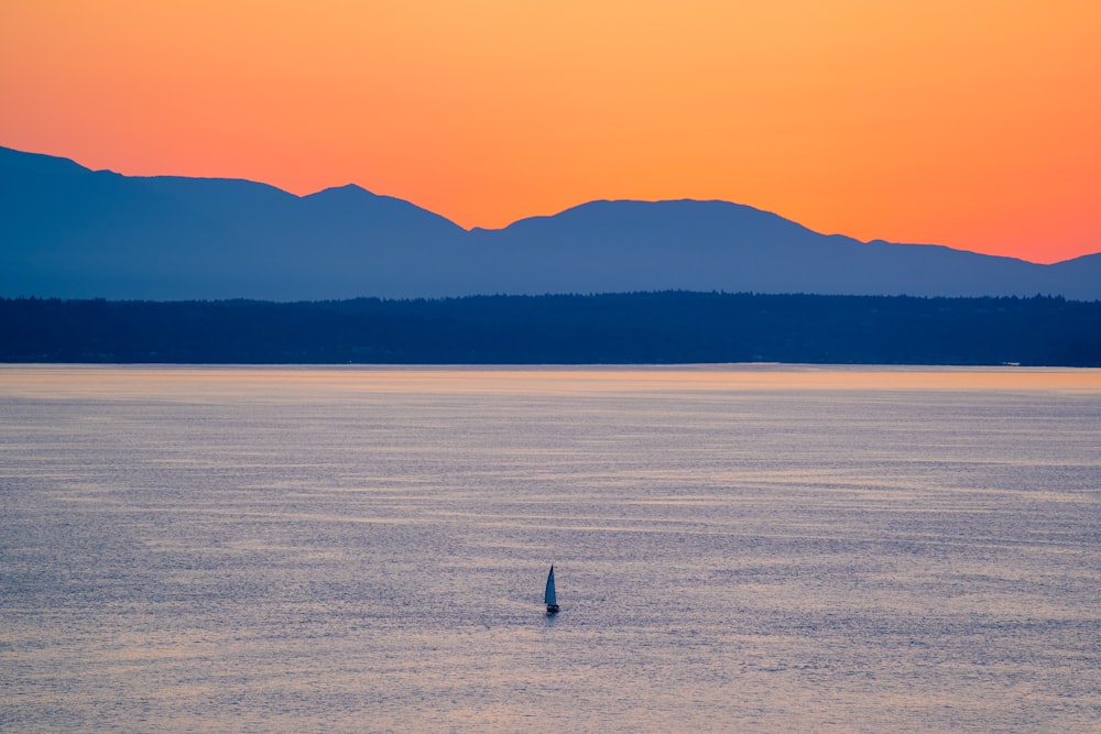 a lone boat in the middle of a large body of water