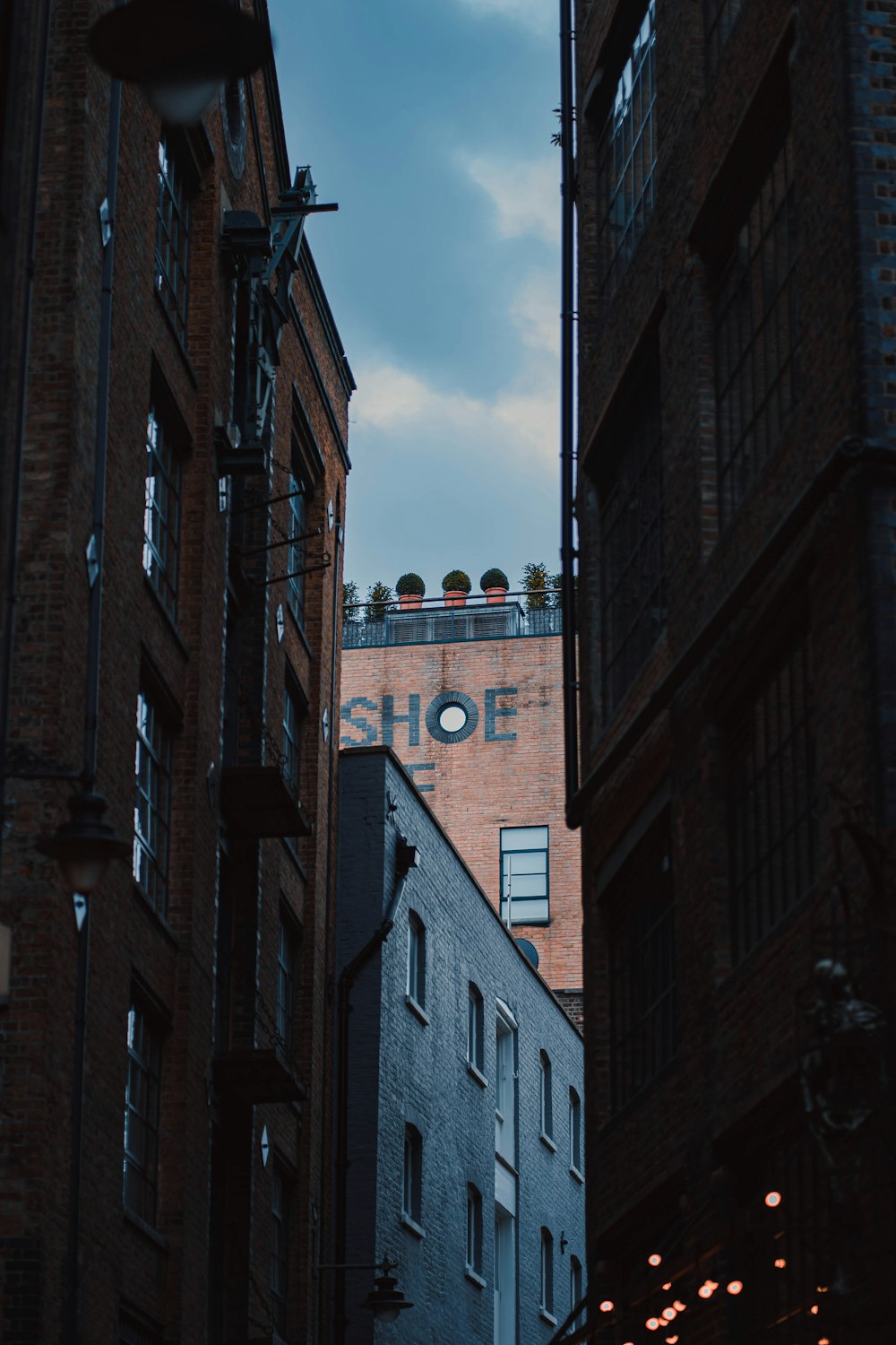 a tall brick building with a clock on it's side