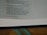 An open book displaying text with a focus on certain passages that discuss spiritual and moral themes. The page is light-colored with black printed text and a teal ribbon bookmark partially visible at the bottom. The book rests on a wooden surface.
