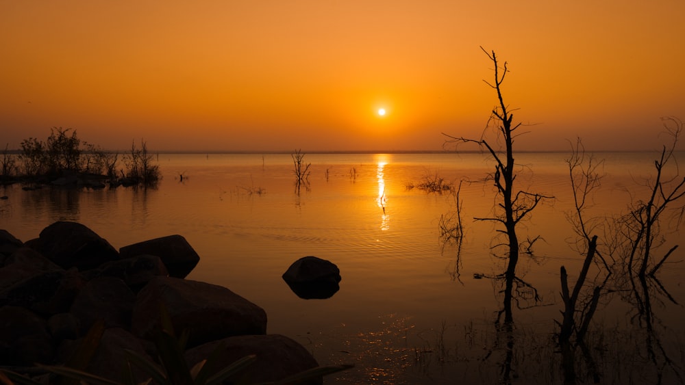 the sun is setting over a body of water