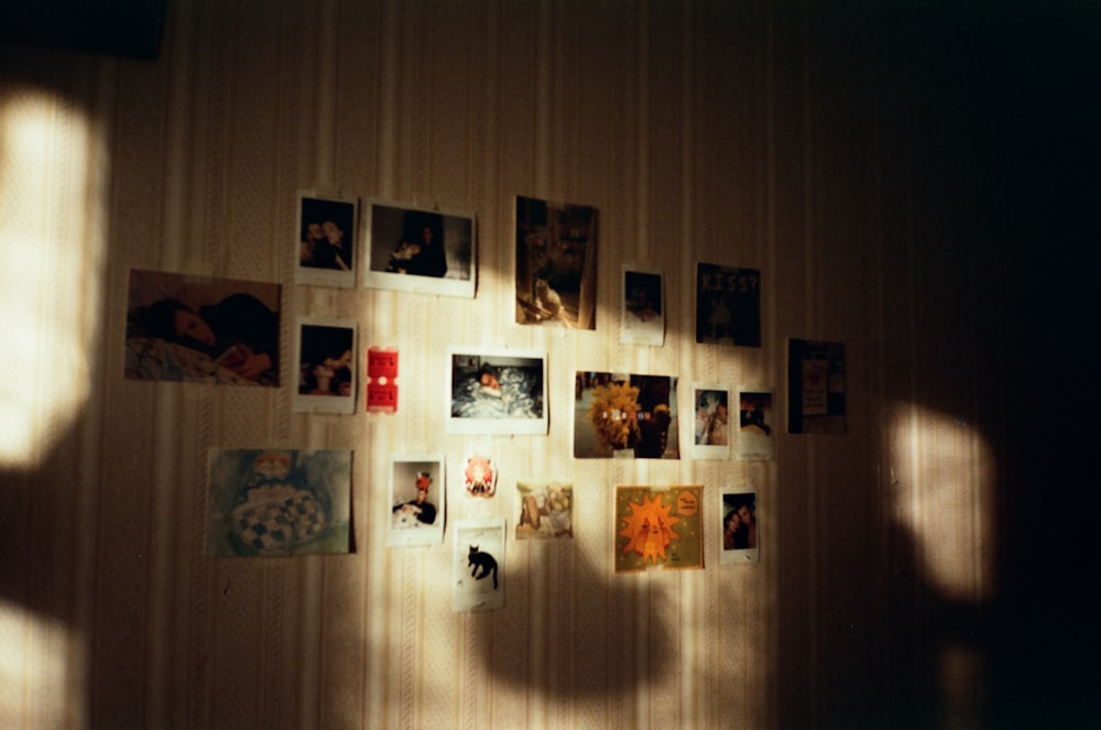 a wall with a bunch of pictures hanging on it