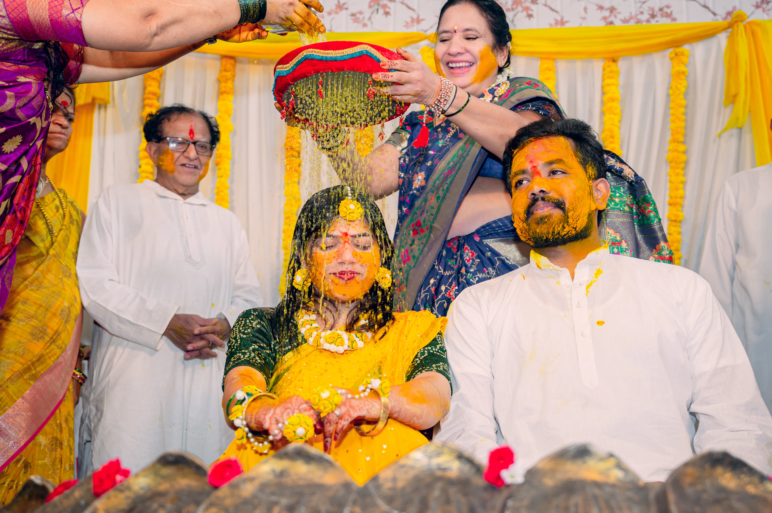 Group of people gathered together during a turmeric ceremony