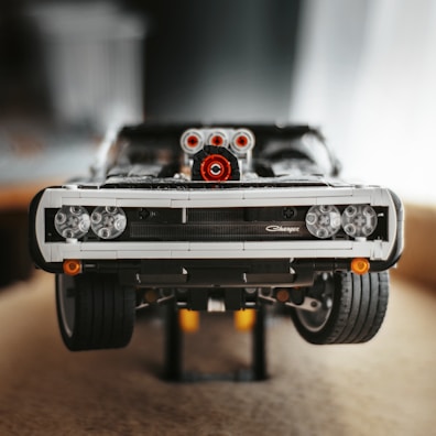 An intricate adult assembly kit model of a vintage car made from precise blocks.