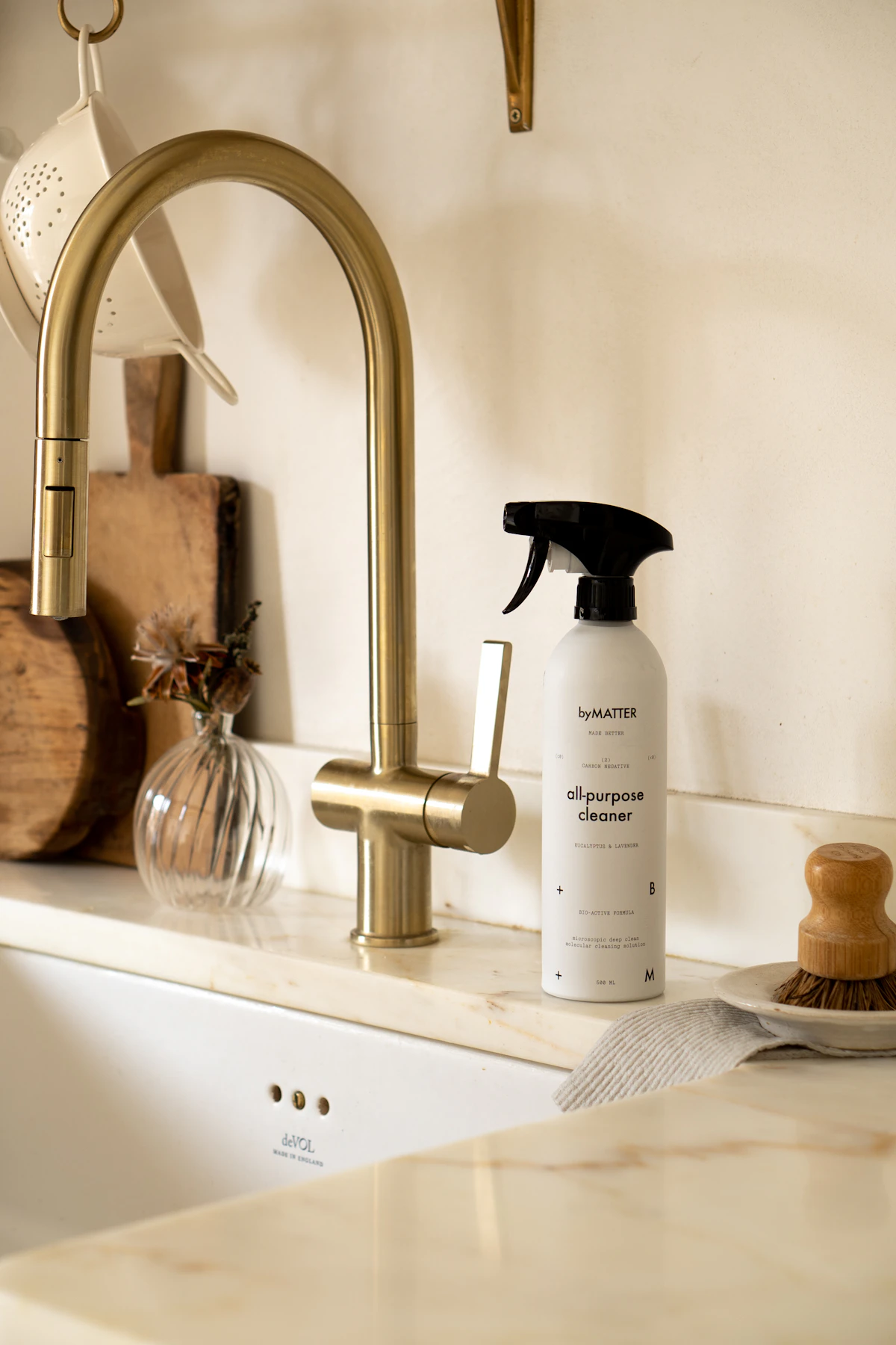 Bottle of cleaner set beside a kitchen sink