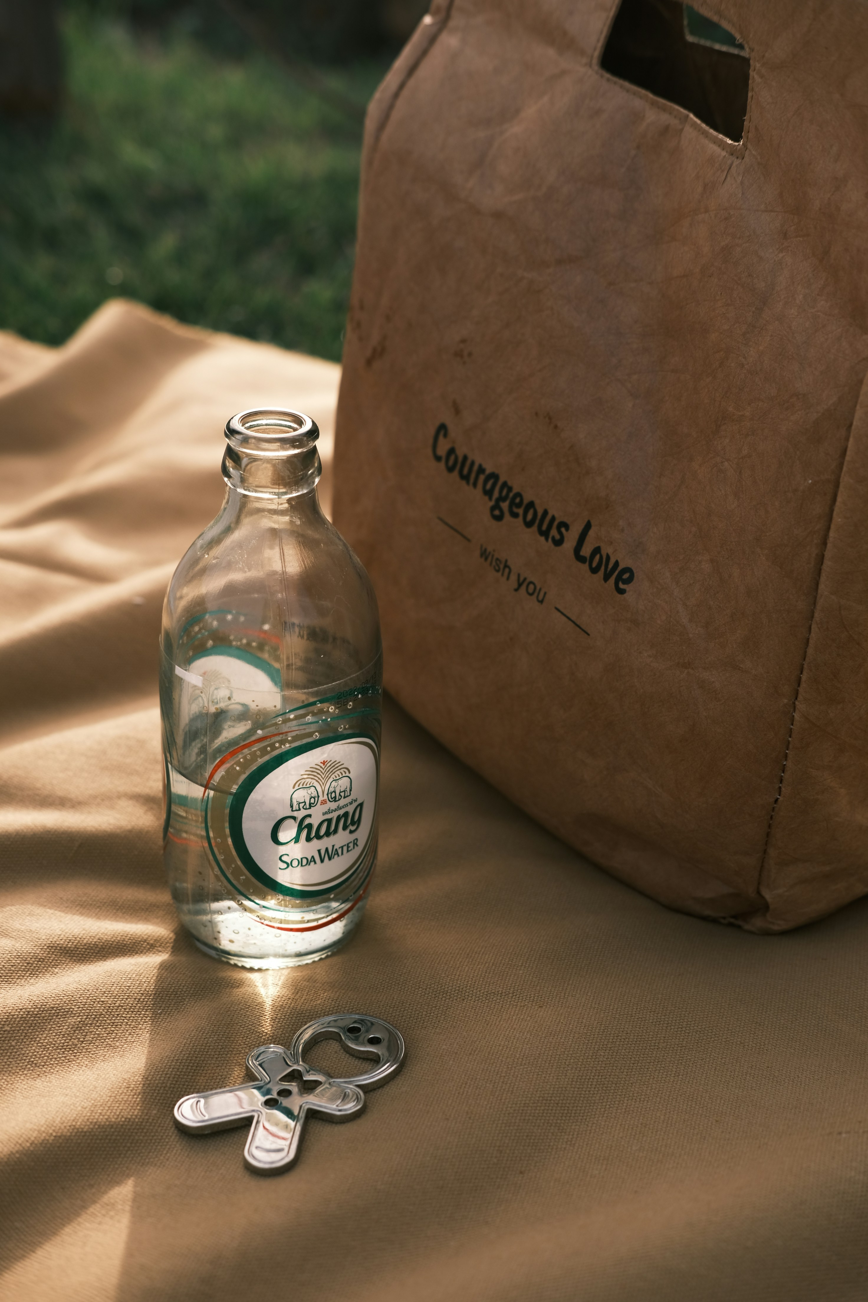 a bottle of water sitting on a table next to a bag