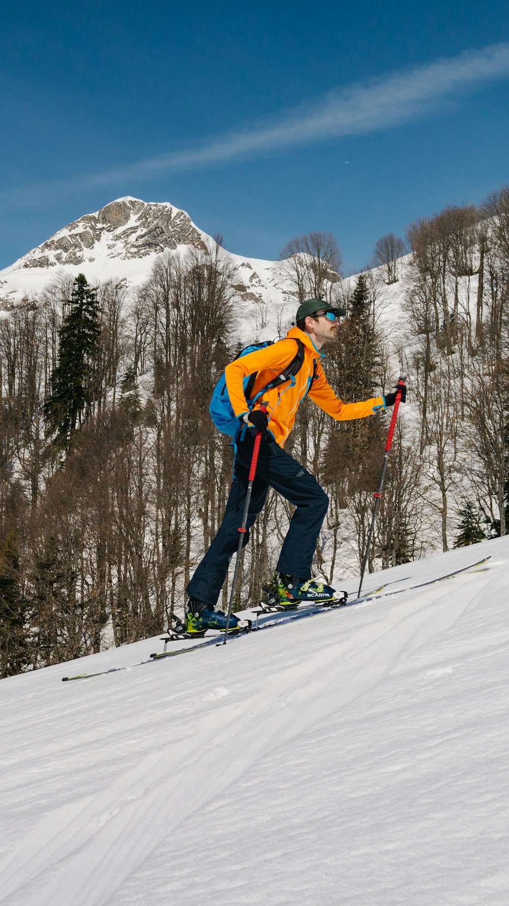 a man riding skis down a snow covered slope