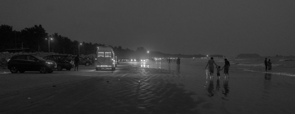 a black and white photo of a beach at night