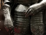 A close-up of a warrior's armor reflecting sunlight.