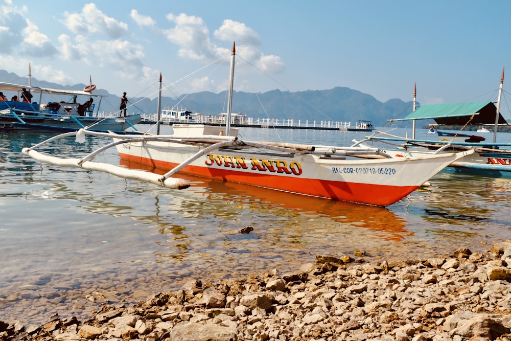 a group of boats floating on top of a body of water