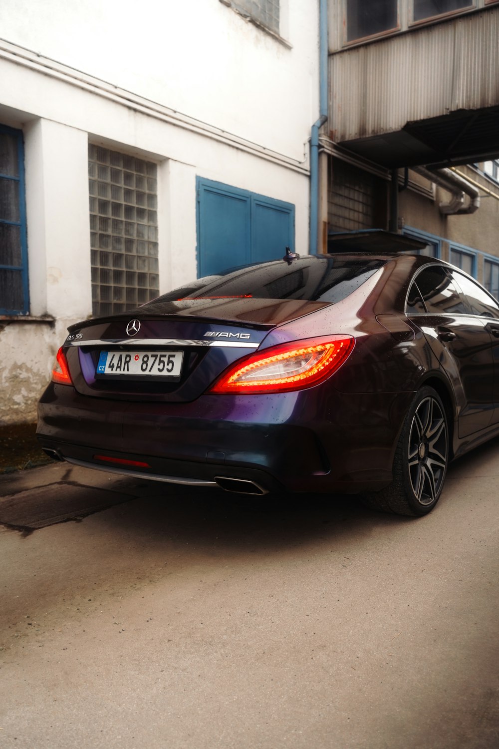 a black car parked in front of a building