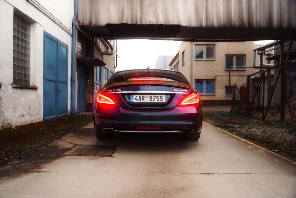 a car parked under a bridge on a city street