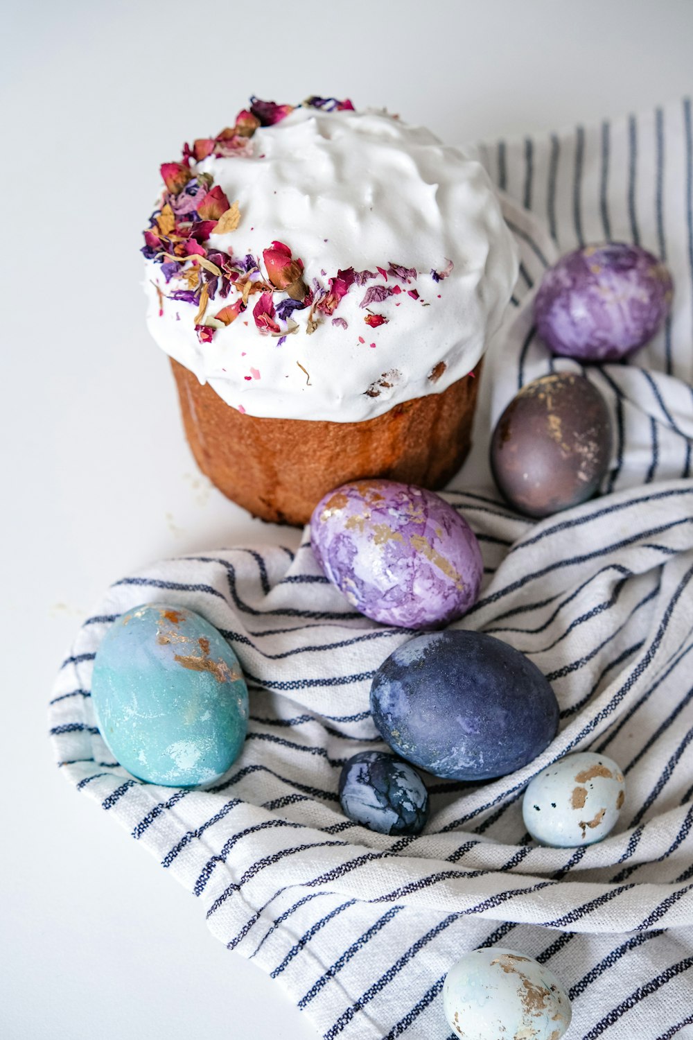 a cupcake sitting on top of a towel next to eggs