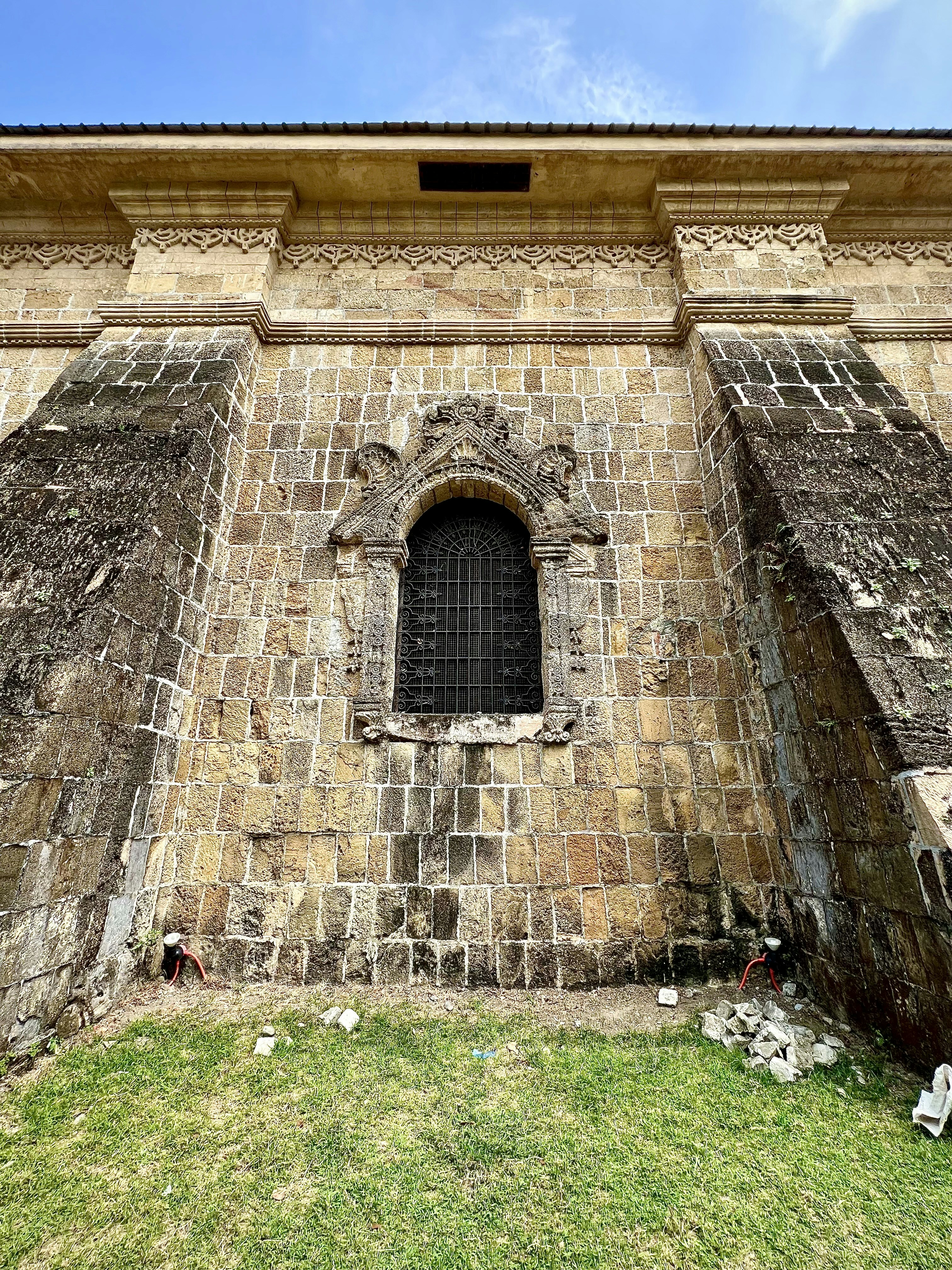un edificio de piedra con una ventana en el costado