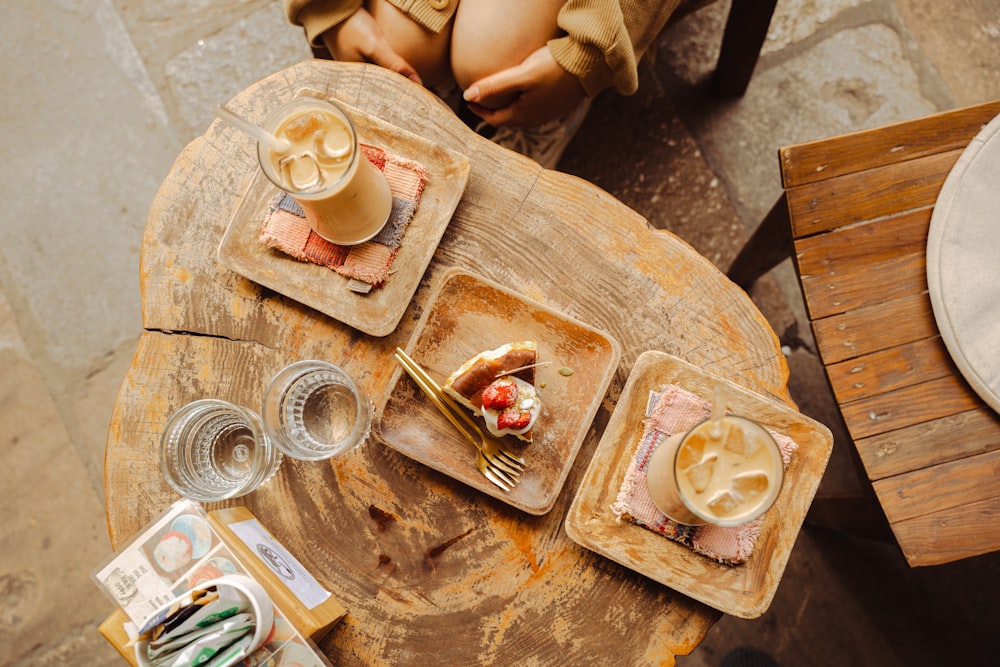 a wooden table topped with plates of food