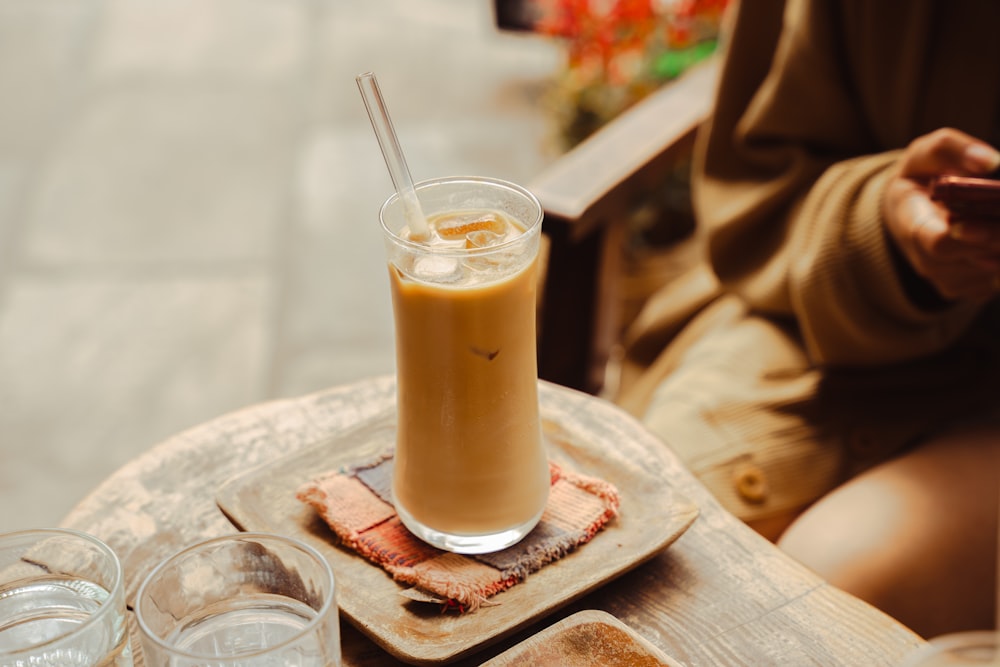 a drink sitting on top of a wooden table