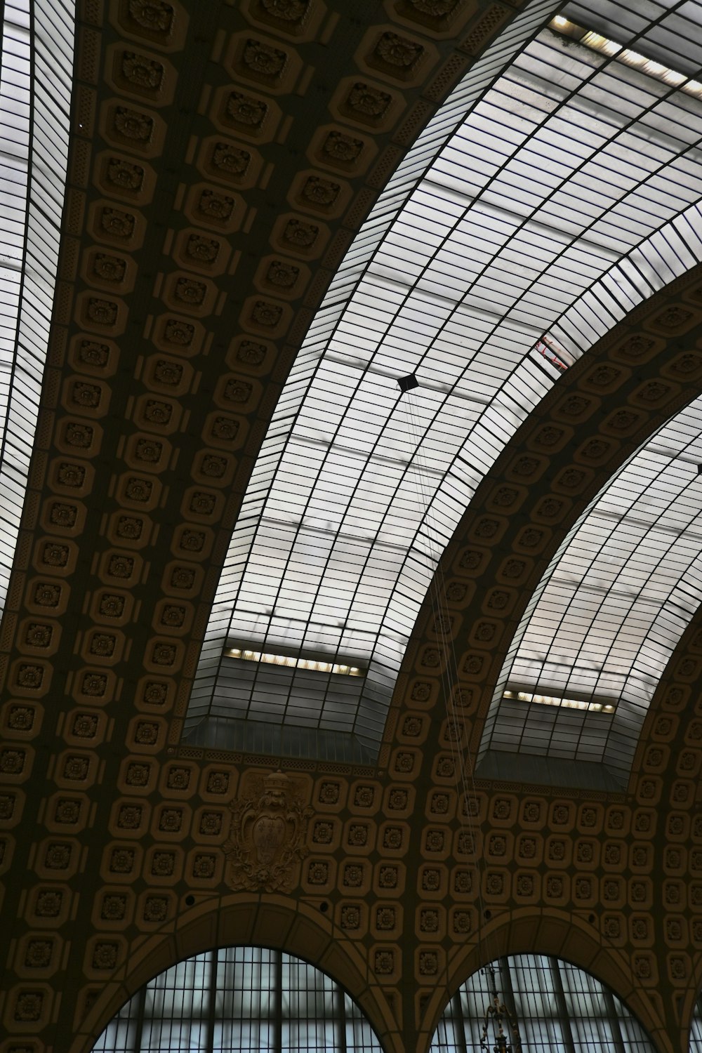 the ceiling of a train station with many windows