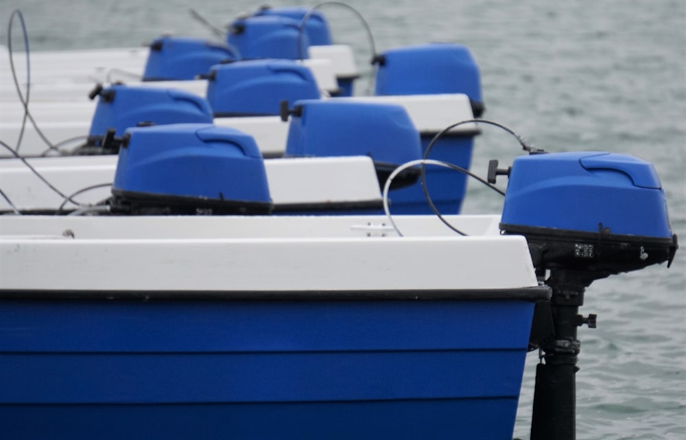 a row of blue and white boats in the water