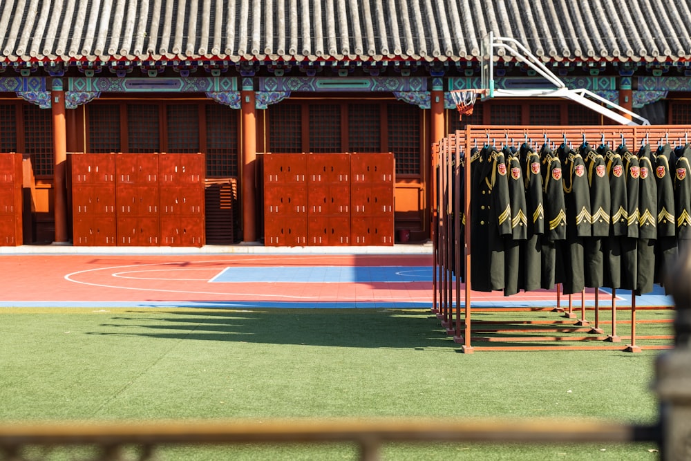 a group of military uniforms hanging on a rack