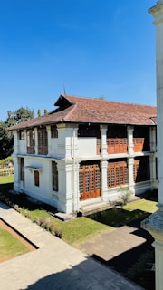 a large white building with a brown roof