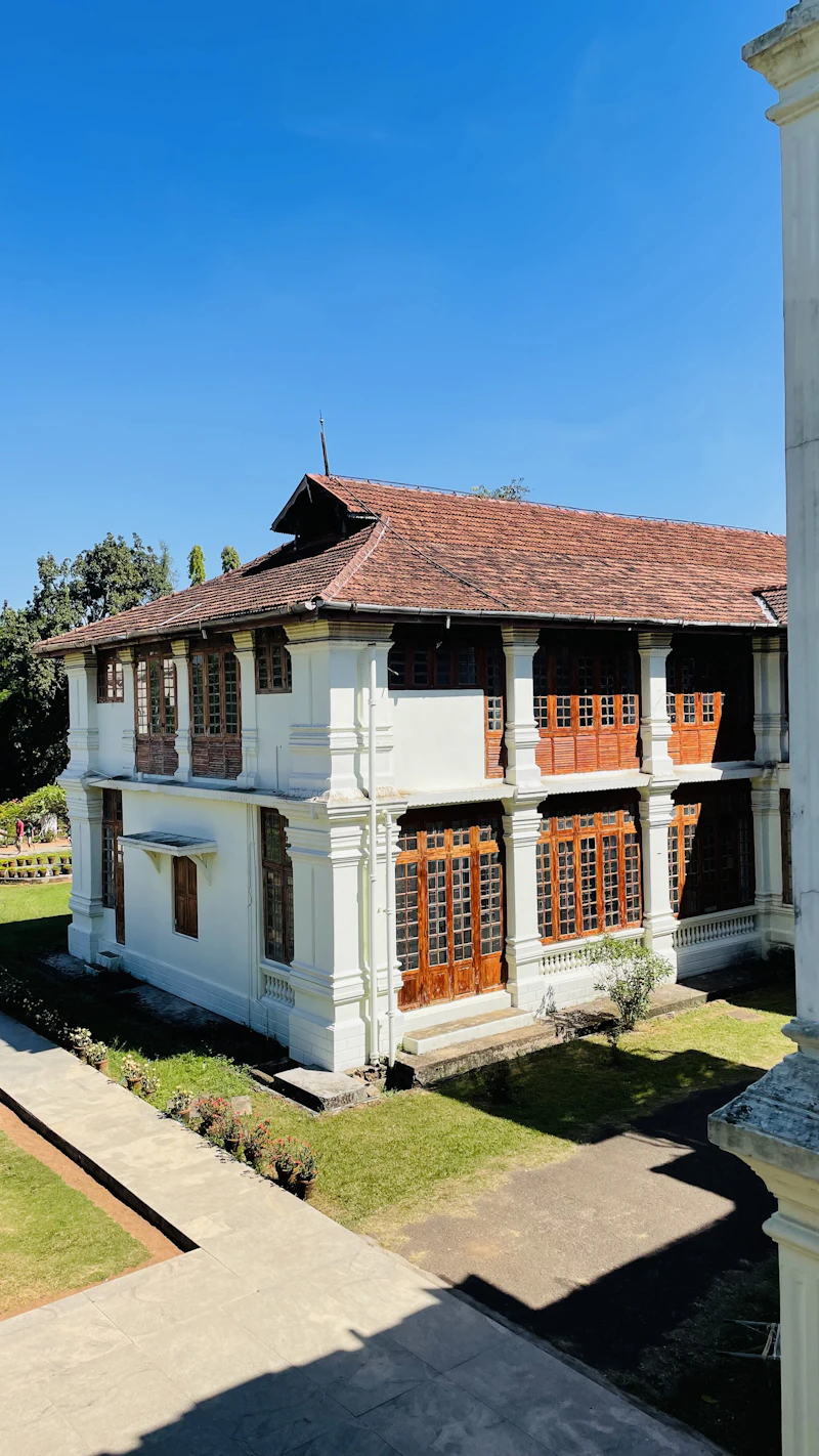 A large white heritage house with a brown tiled roof in Kochi, Kerala