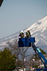 a couple of men standing on top of a blue lift