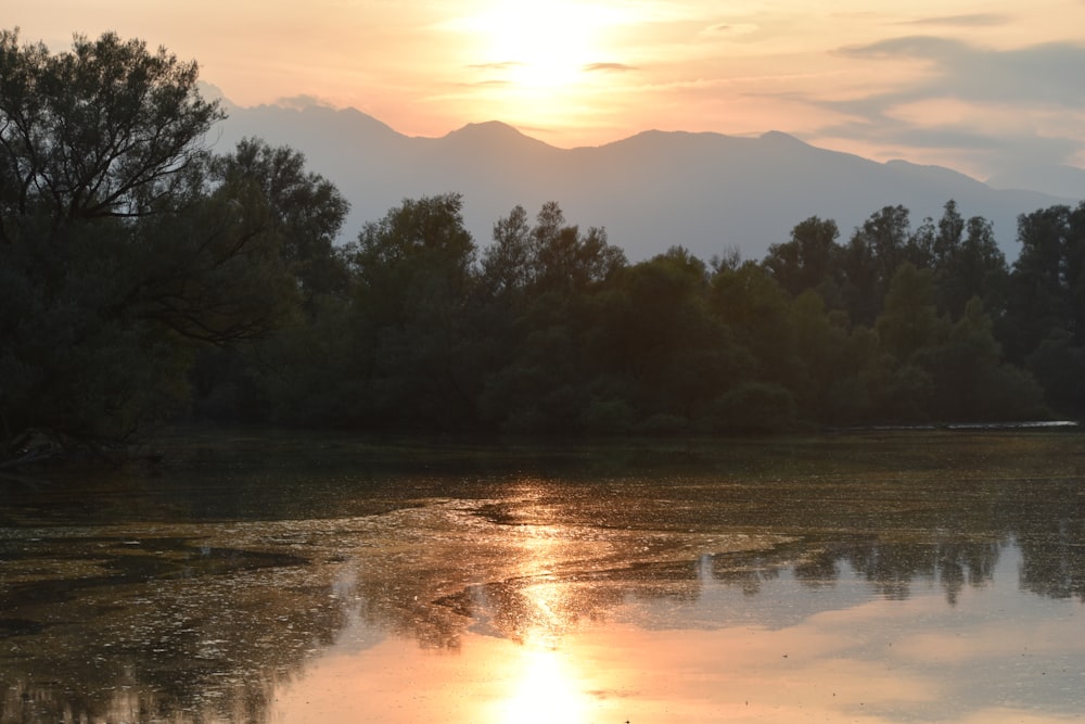 the sun is setting over a body of water