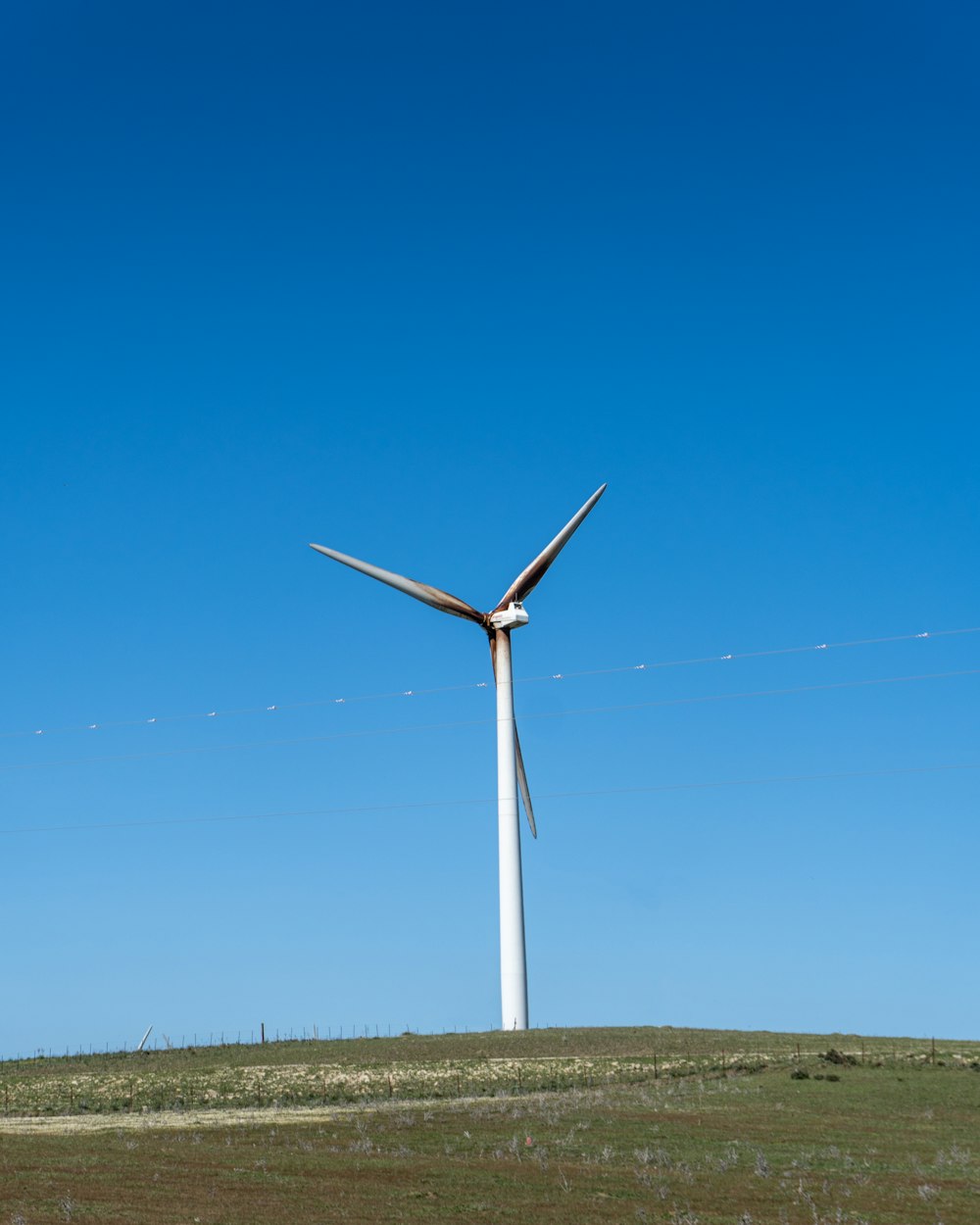 a wind turbine on top of a hill