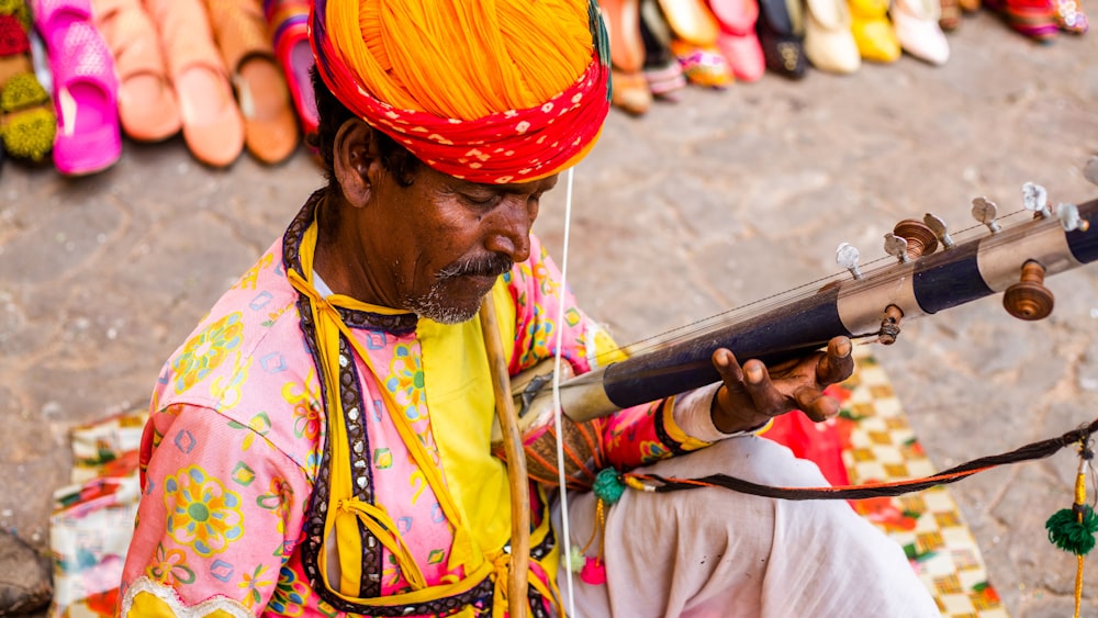 a man in a colorful outfit holding a telescope