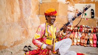 a man sitting on the ground with a sword in his hand