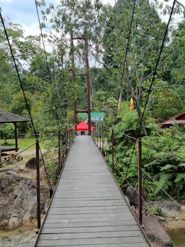 A modular bridge spanning a rural river, connecting two small communities.