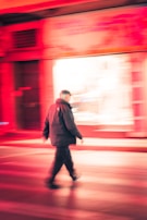 Dynamic shot of a model walking through a busy street wearing a Lumina jacket.