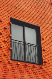 a red brick building with two windows and bars